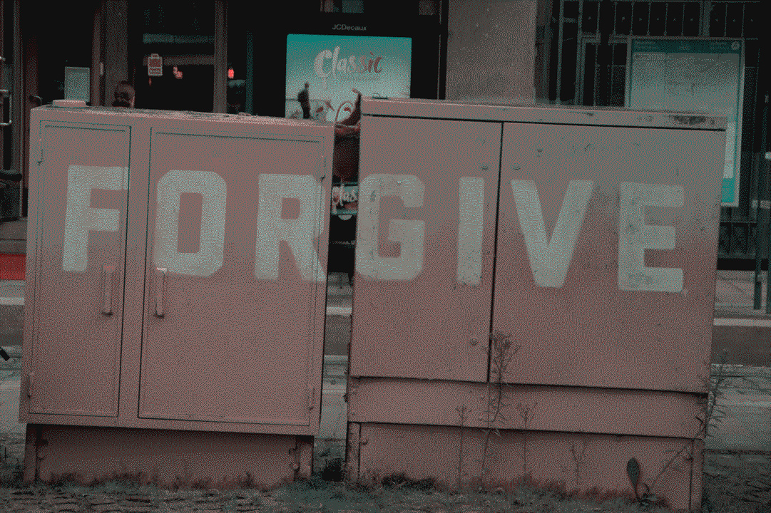 The Helsinki city center with electric boxes in the center that spell the word "forgive"